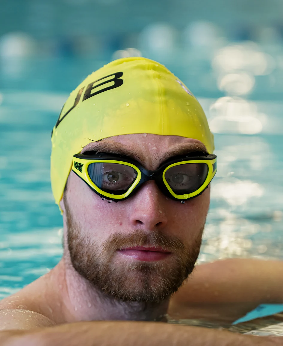 Bright orange HUUB silicone swim cap with a snug fit, designed for comfortable and streamlined swimming.