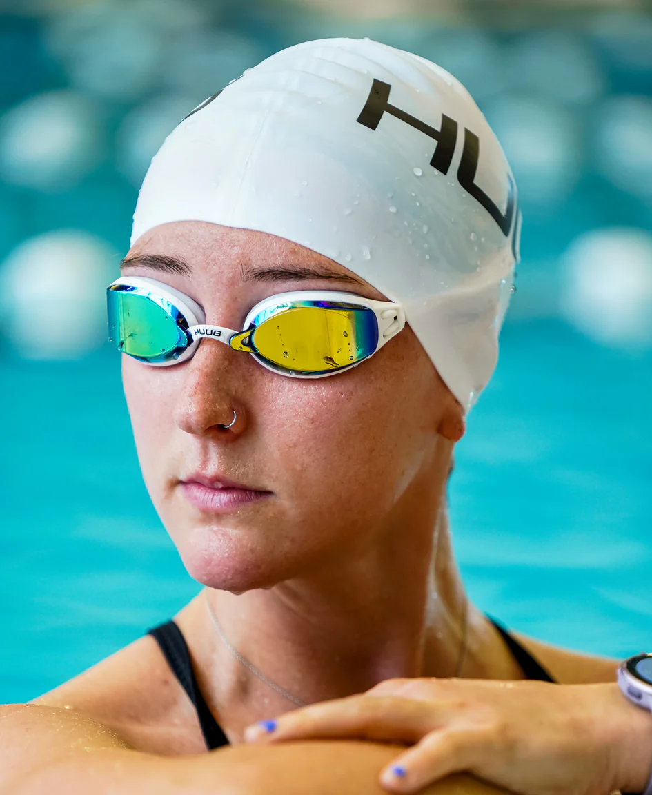 Bright orange HUUB silicone swim cap with a snug fit, designed for comfortable and streamlined swimming.